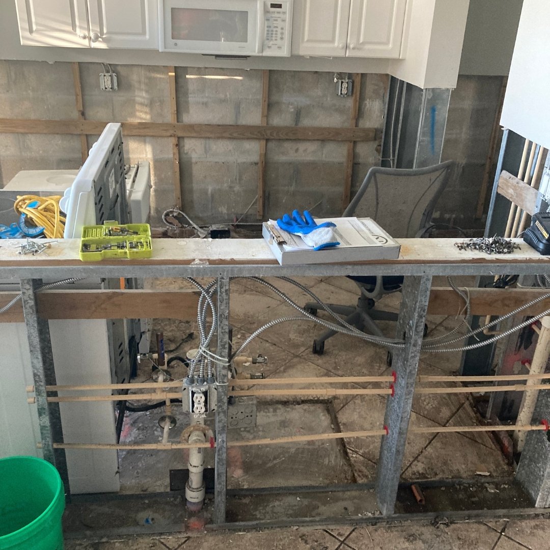 Image of kitchen reconstruction in condo following water damage from hurricane ian 