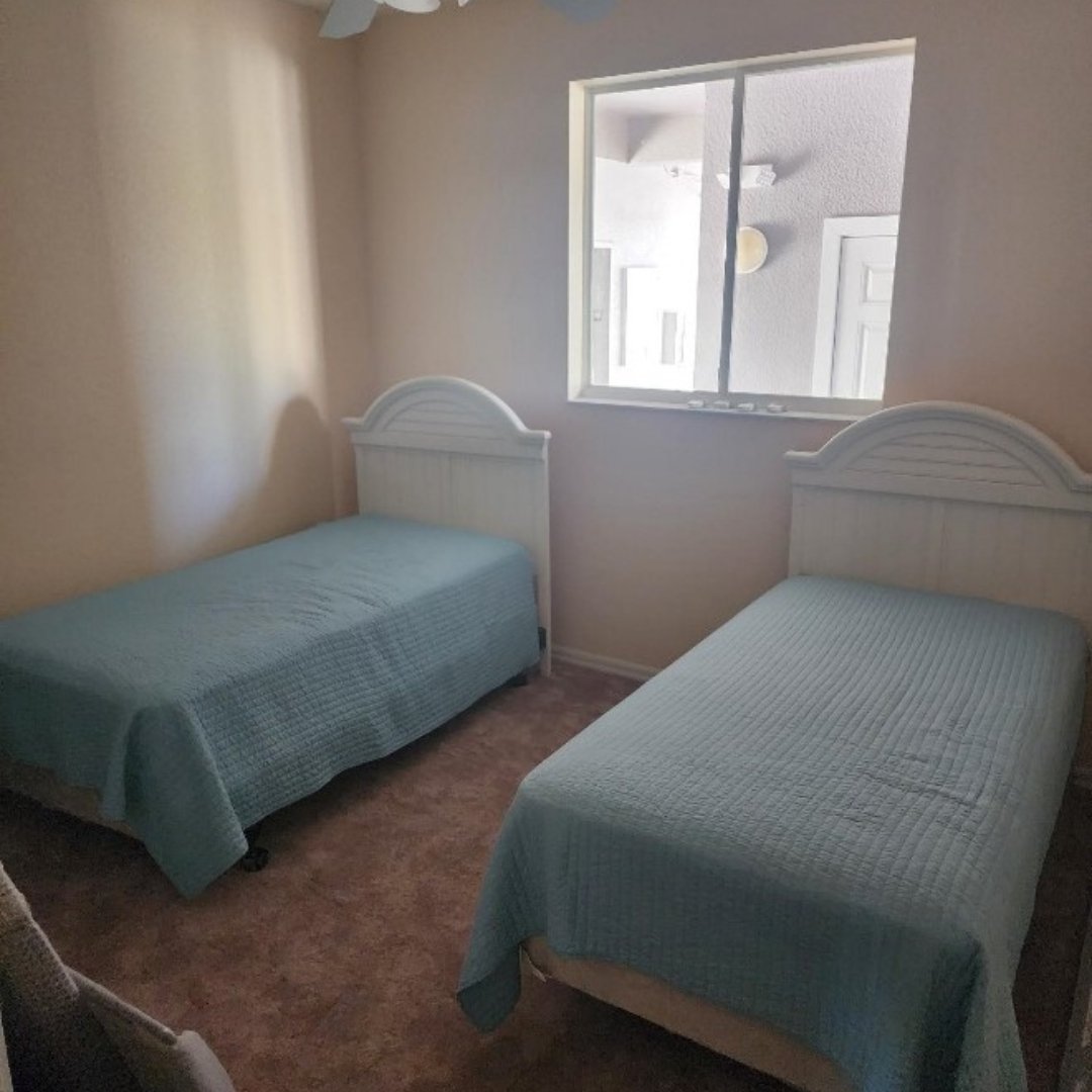 Image of two twin beds in condominium after restoration provided by CRC 