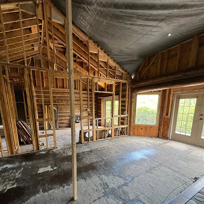 Image of a fire damaged log cabin prior to restoration services performed by CRC