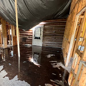 Flooding and water damage in remote resort log cabin. 