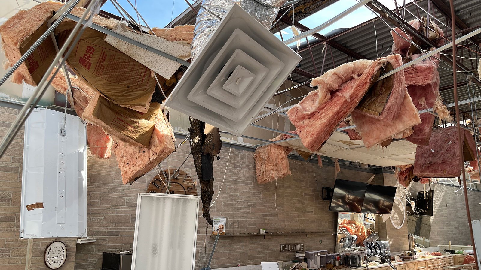 Exposed retail space after tornado tore roof off of strip mall.