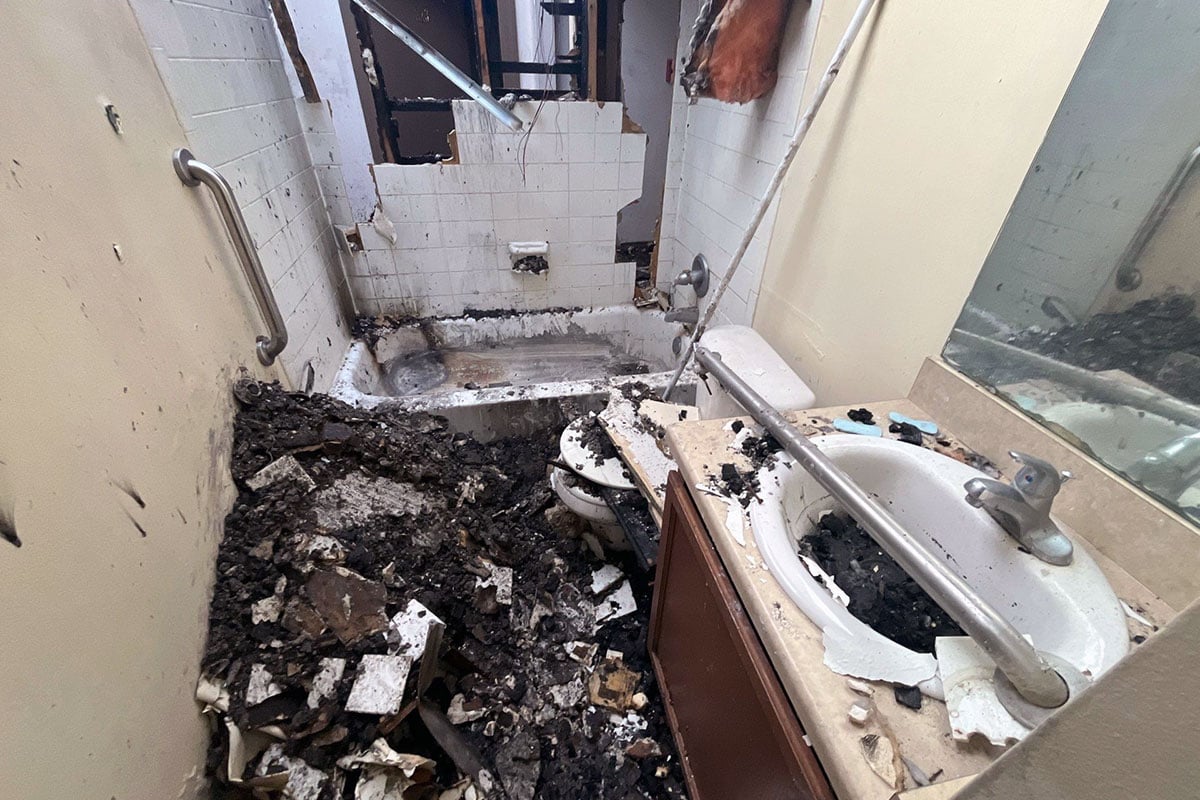 Damaged-bathroom-filled-with-debris-from-fire