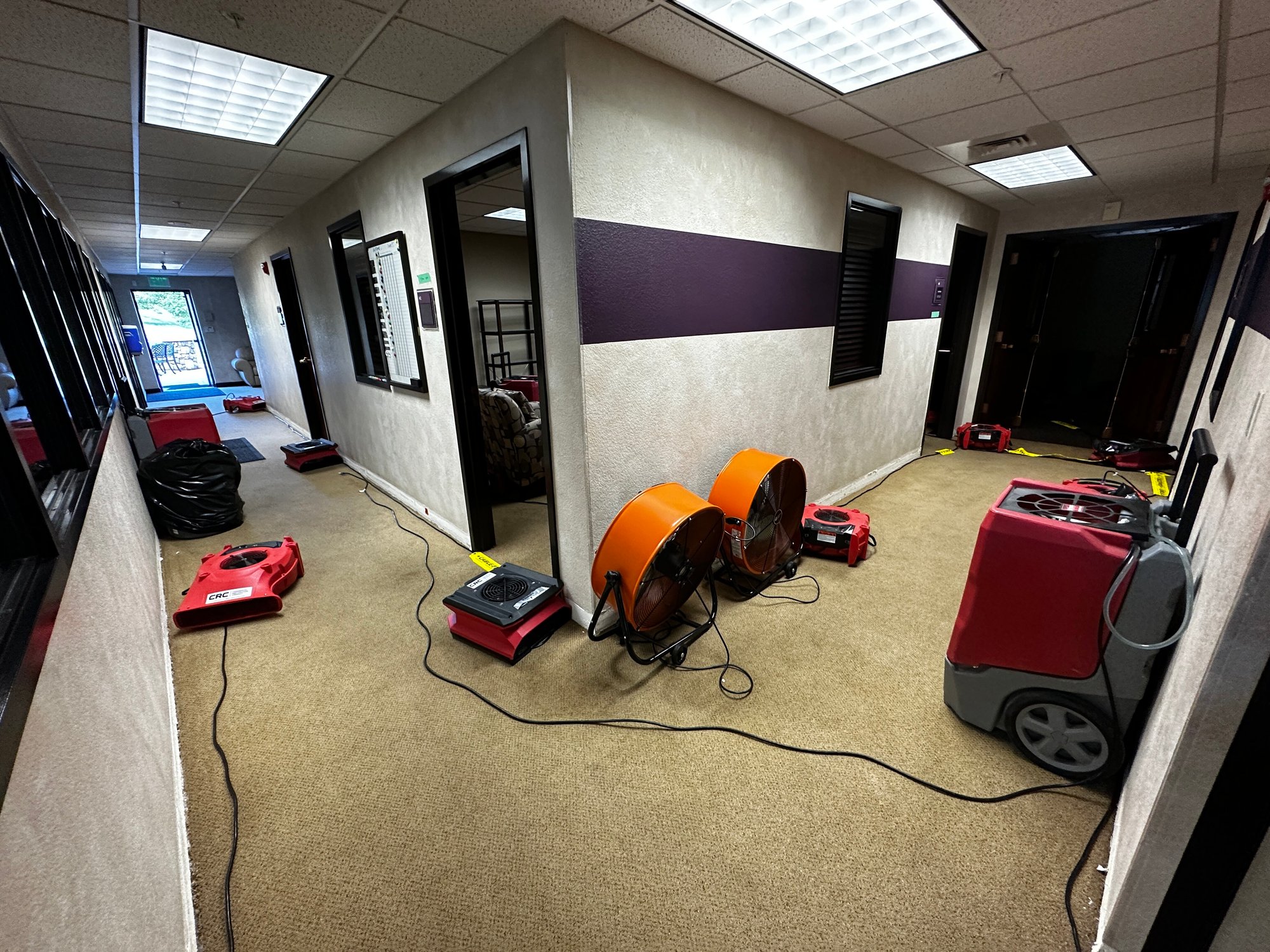 Image of church hallway under mitigation after overnight pipe burst led to water damage