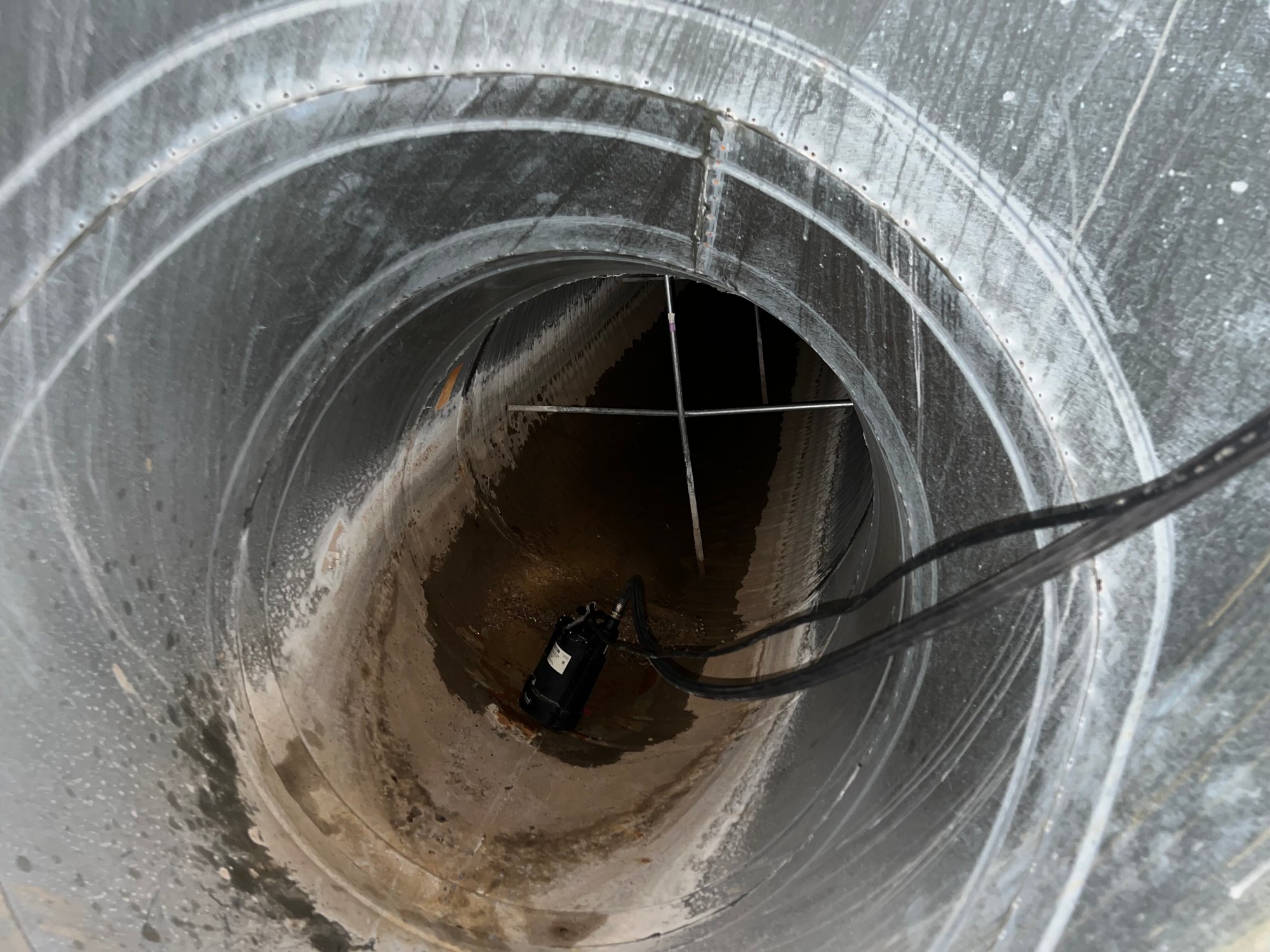 Photo of water removal from pipe after church flooding