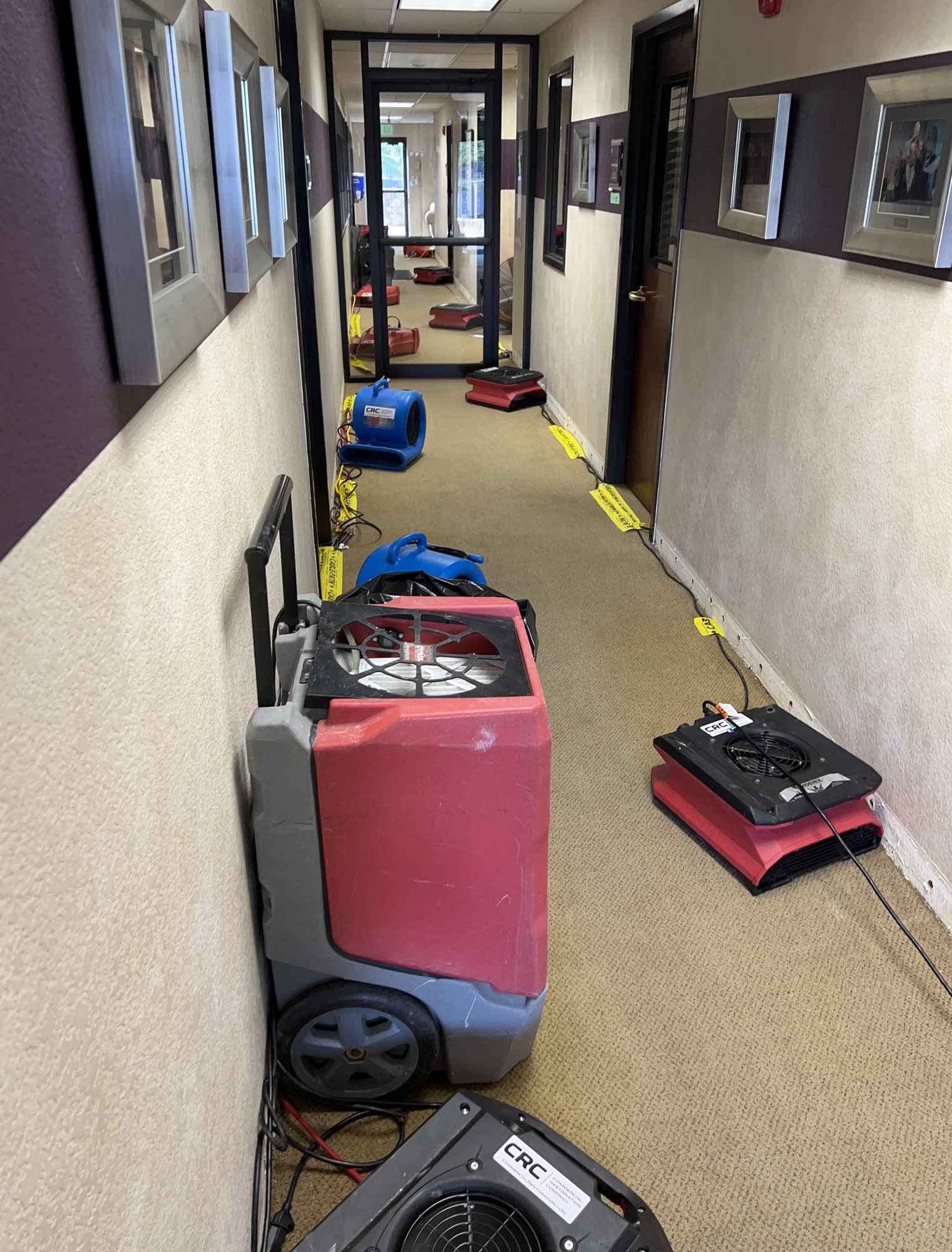 Image of church hallway being dried by commercial restoration company following flooding after pipe burst 