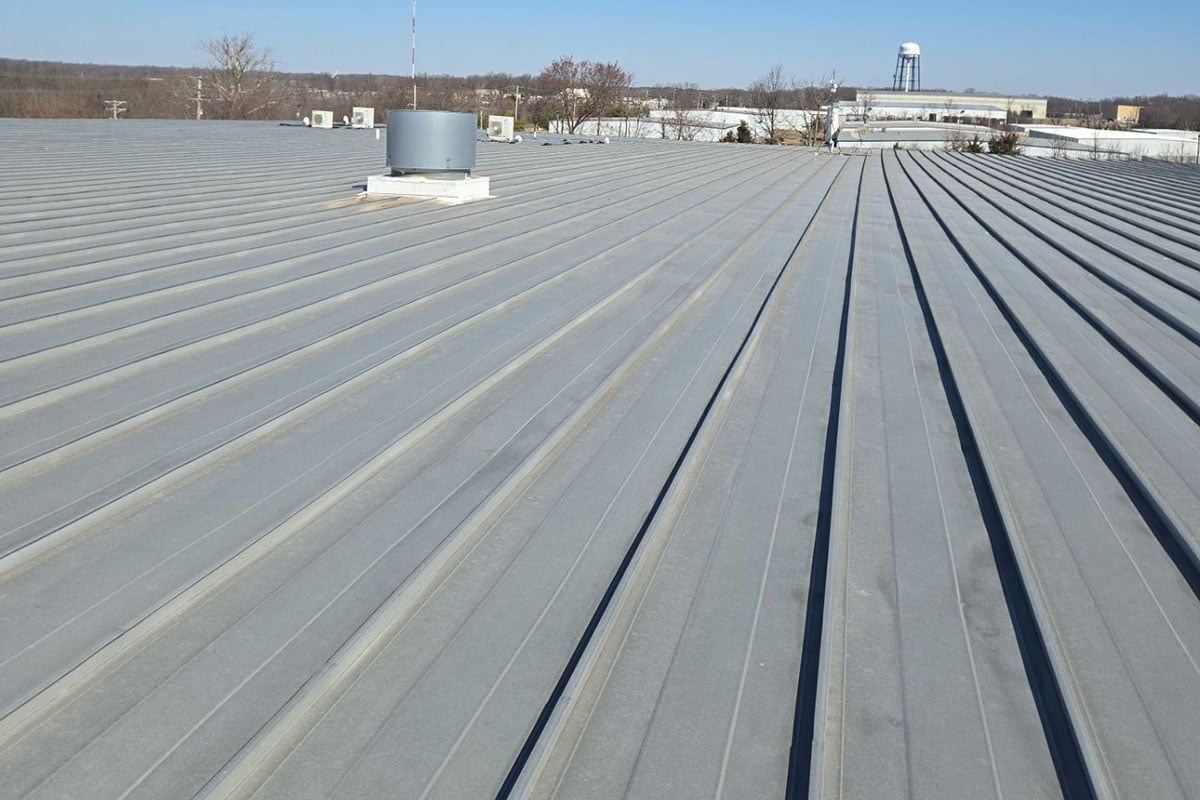 Metal roof on manufacturing plant damaged by hail