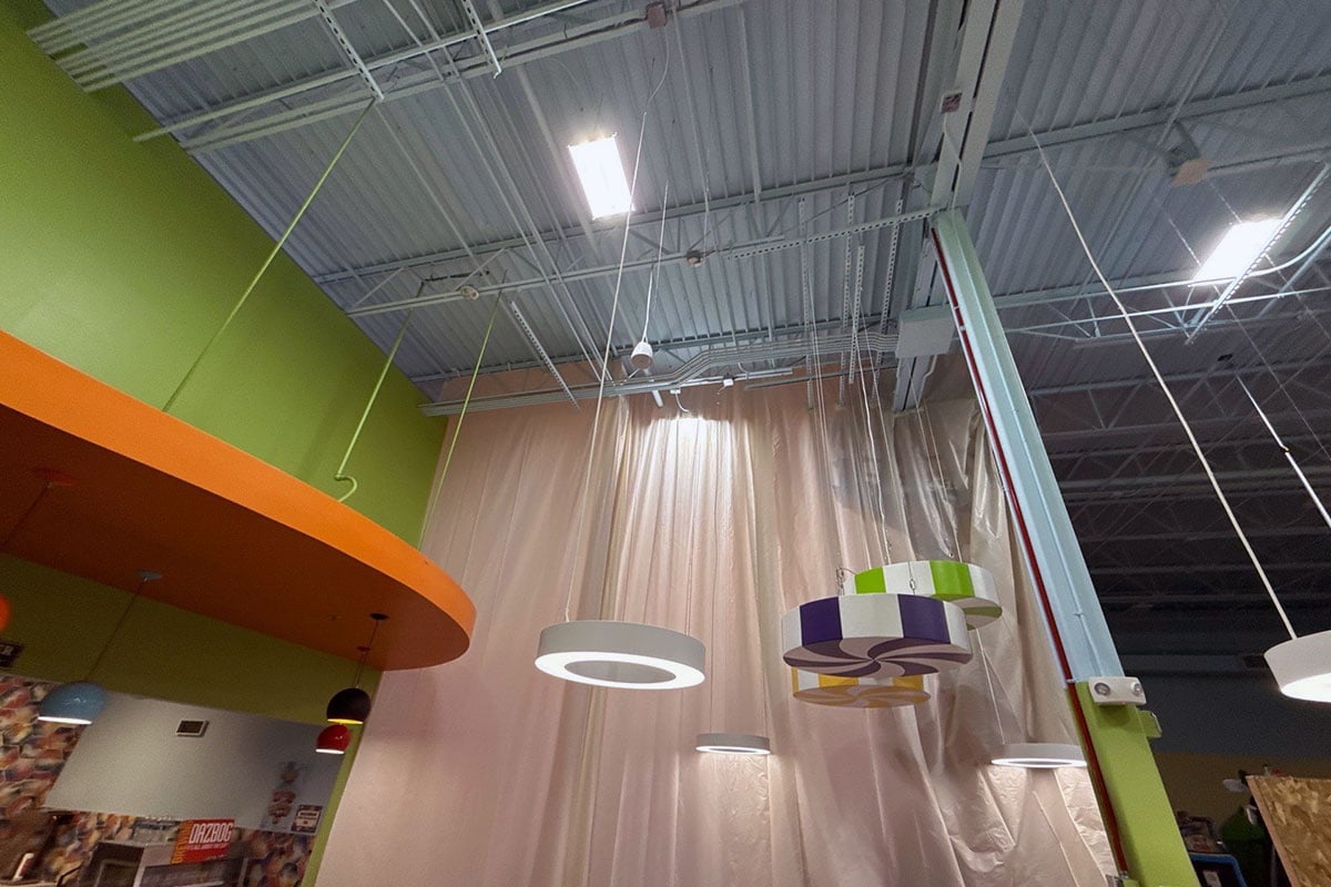 Containment walls being installed 20+ feet high in indoor play facility.