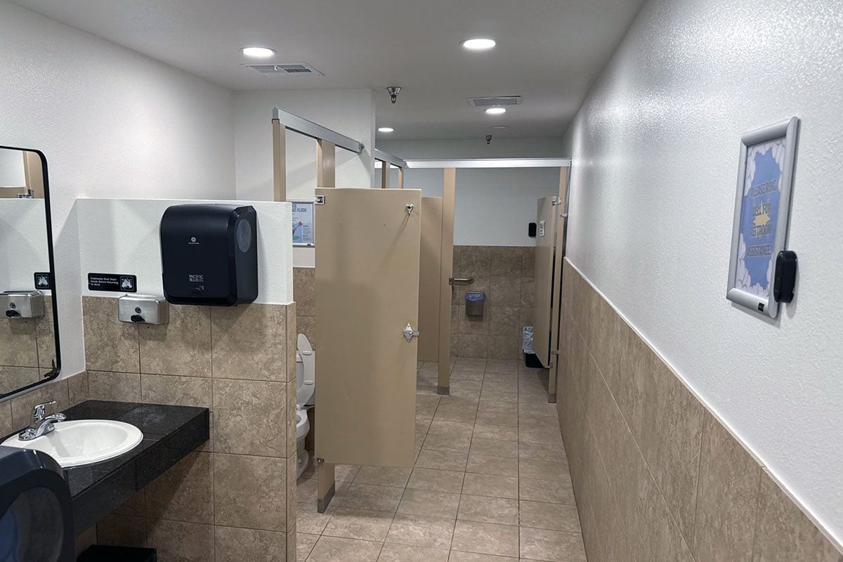 Bathroom restored after sustaining water damage from fire suppression system putting out fire in indoor play facility.