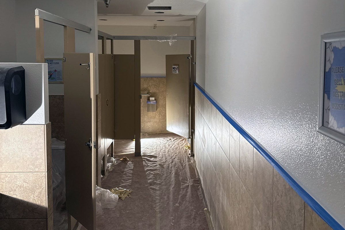 Bathroom during restoration after sustaining water damage from fire suppression system putting out fire in indoor play facility.