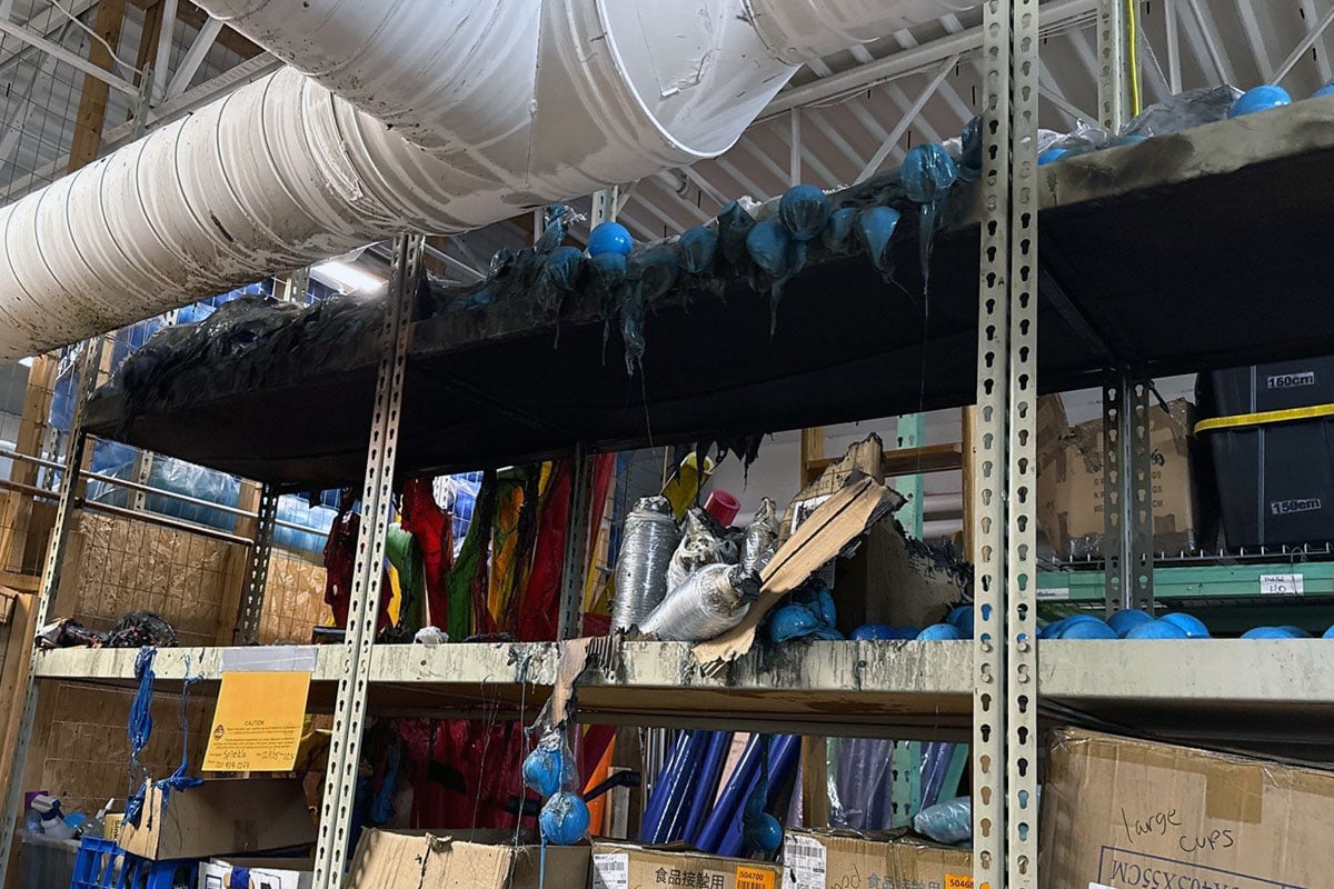 Melted plastic balls dripping down storage shelves after fire.