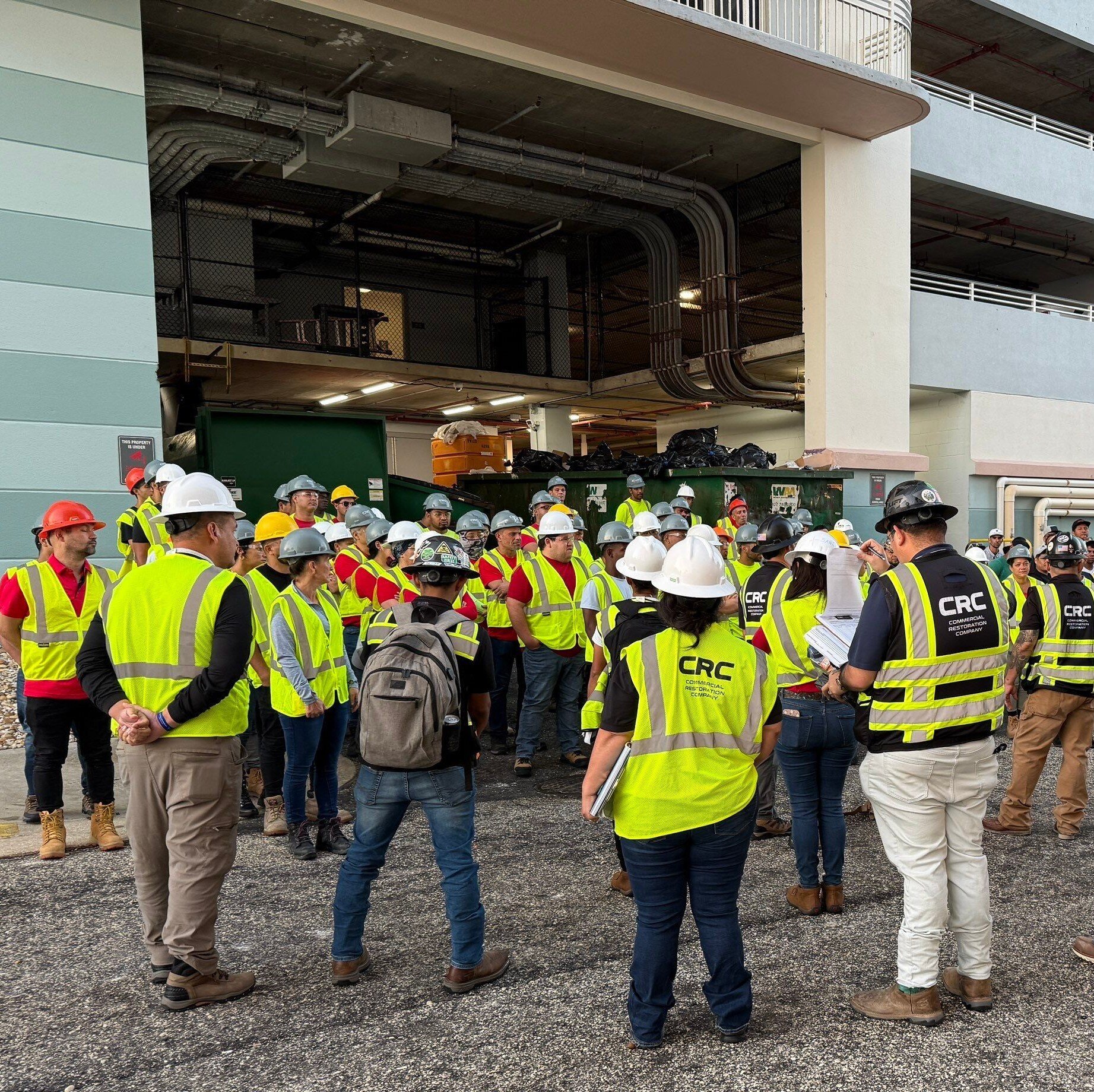 Photo of CRC team meeting to plan FL resort restoration and discuss safety. 