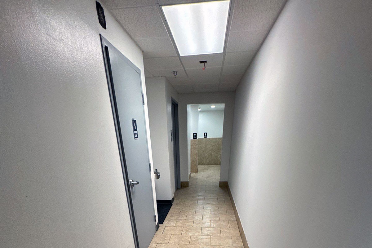 View of hallway into bathroom after full fire damage restoration.